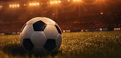 Visuel d'illustration : un ballon de football posé sur la pelouse d'un stade éclairé le soir